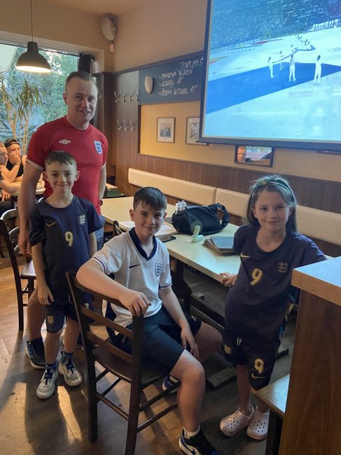 Murtagh family wearing England Football shirts watching the Euro 2024 final match