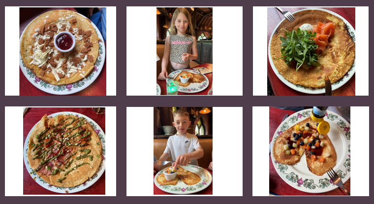 A plate of Dutch pancakes topped with powdered sugar and a side of jam, presented on a decorative plate.