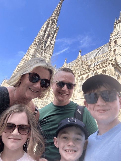 The Murtagh family smiling in front of St Stephens Cathedral in Vienna